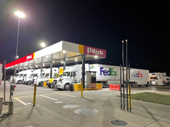 Photo — a roadside truck stop filled with 18-wheelers